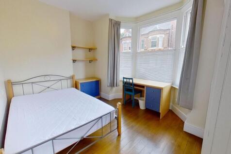 Bright furnished bedroom with a double bed, woo...