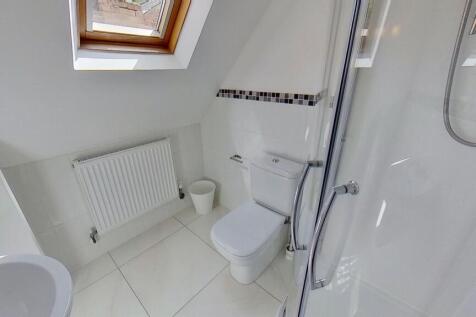 Bright, modern bathroom with white tiles, a cor...