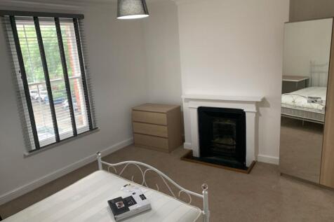 Bright, neatly presented bedroom with a decorat...