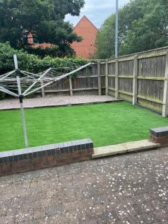 Enclosed rear garden with low brick boundary, n...