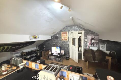 A spacious and well-lit living room with modern...