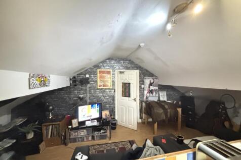 A spacious and well-lit contemporary living roo...