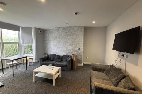 A spacious and well-lit living room featuring c...