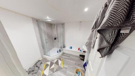 A spacious, modern bathroom featuring a large b...