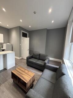 A modern, well-lit living room featuring sleek ...