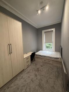 A neat and well-maintained single bedroom with ...