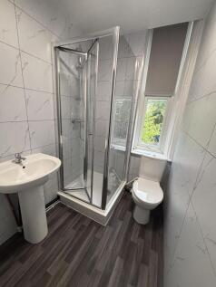 A clean and modern bathroom with a stylish show...