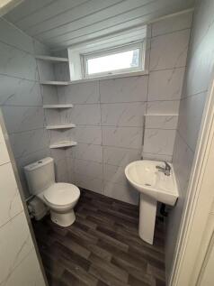 Modern and tidy bathroom featuring a toilet, a ...