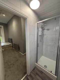 A clean and modern bathroom with a glass enclos...