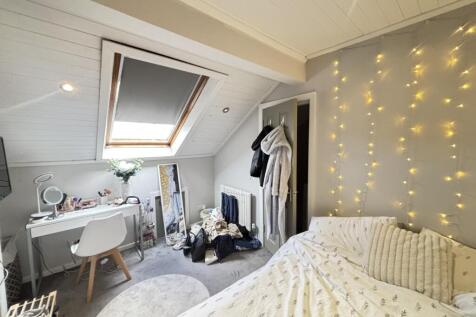 A spacious and inviting master bedroom with a c...