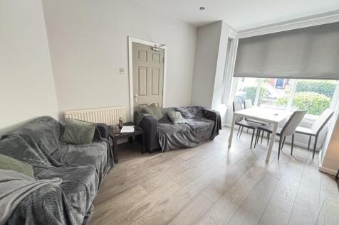 A spacious, naturally well-lit living room with...