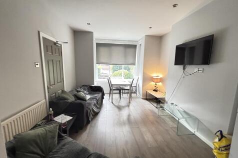 A spacious and modern living room with ample na...