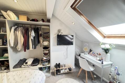 A cozy bedroom with a neatly organized wardrobe...