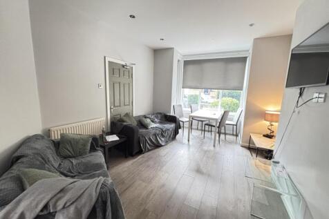 Bright and spacious living room featuring large...