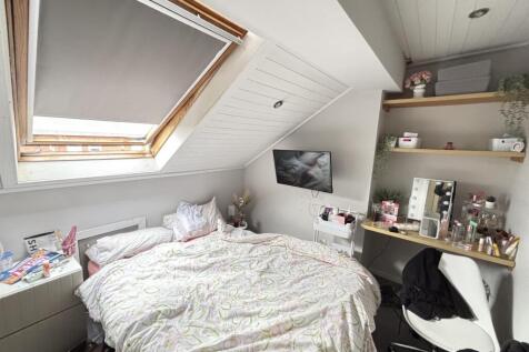 A bright and cozy bedroom featuring a double be...