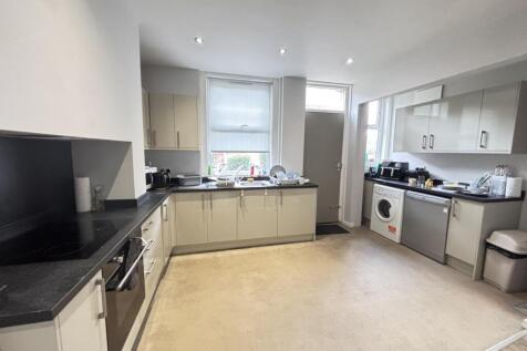 Bright and modern kitchen with ample white cabi...