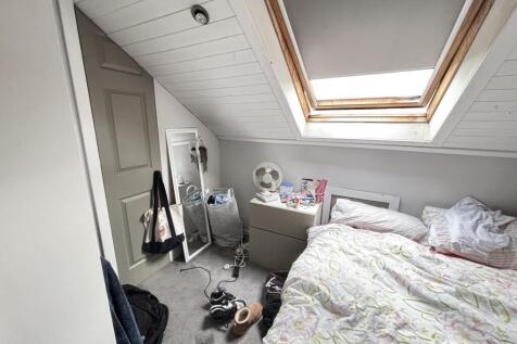 A bright and cozy bedroom featuring a double be...