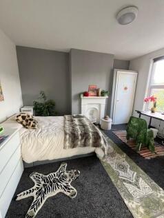 Bright and spacious master bedroom featuring a ...