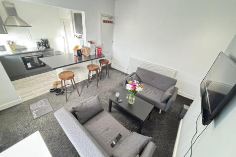 Modern and inviting living room featuring comfo...