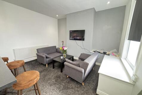 A bright, modern living room featuring a contem...