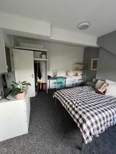 A well-organized bedroom with a comfortable dou...