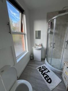Bright and clean bathroom featuring a modern sh...