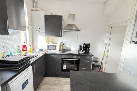 A modern kitchen featuring ample natural light,...