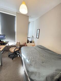 A cozy bedroom featuring a comfortable double b...