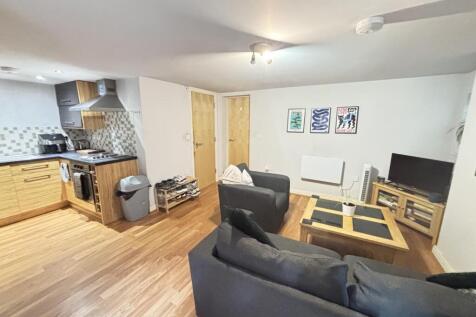 A spacious, modern living room featuring comfor...