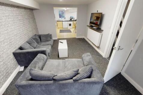 A bright and contemporary living room featuring...