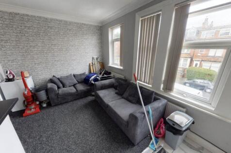 Bright and spacious living room featuring a mod...