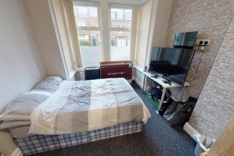 A bright and cozy bedroom featuring a double be...