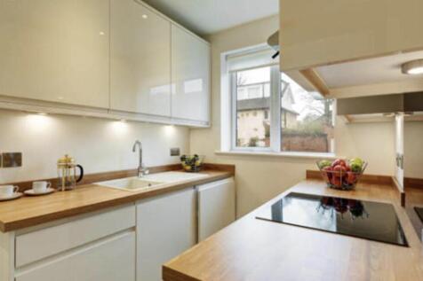 Bright and well-maintained kitchen with ample n...