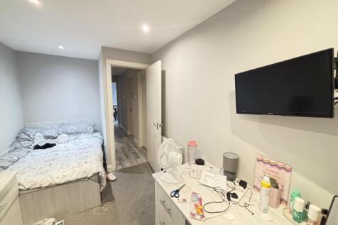 A bright and well-maintained bedroom featuring ...