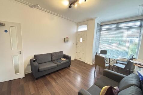 A spacious and bright living room with large wi...