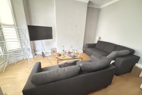 A spacious and well-lit contemporary living roo...