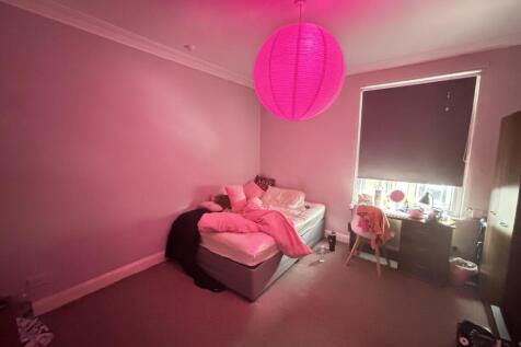 A spacious and inviting master bedroom with a c...