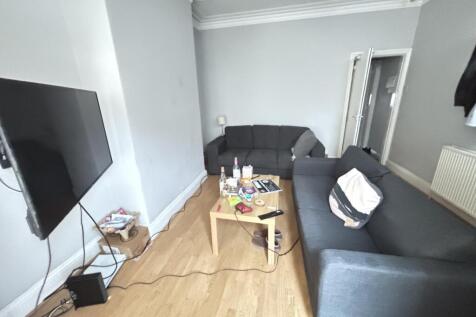 A spacious, modern living room featuring two la...