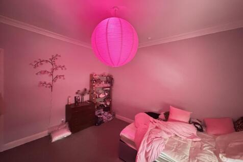 A spacious and bright master bedroom featuring ...