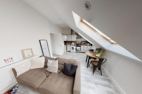 Bright and airy living room with large skylight...