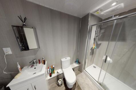 A clean and modern bathroom with a spacious sho...