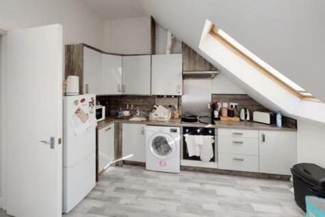Bright and modern kitchen area with ample natur...