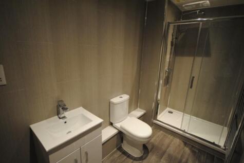 A modern, clean bathroom featuring a spacious s...