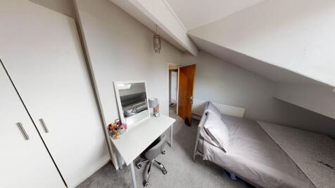 A bright and tidy single bedroom featuring a be...