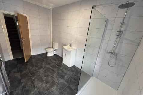 A spacious modern bathroom featuring a large wa...