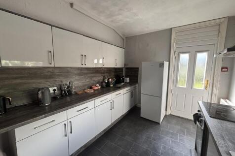A bright and modern kitchen with ample storage ...