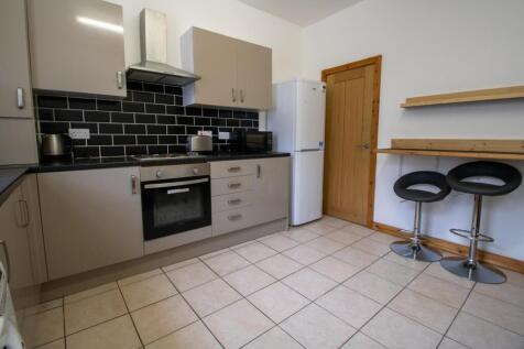 Modern fitted kitchen with neutral cabinetry, i...