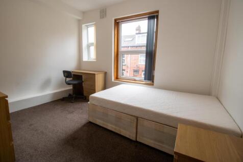 Bright, simply furnished bedroom with a raised ...