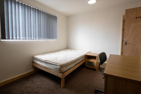 Neat, simply furnished bedroom with a single be...