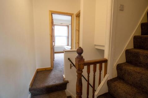 Bright entrance hallway with carpeted stairs an...